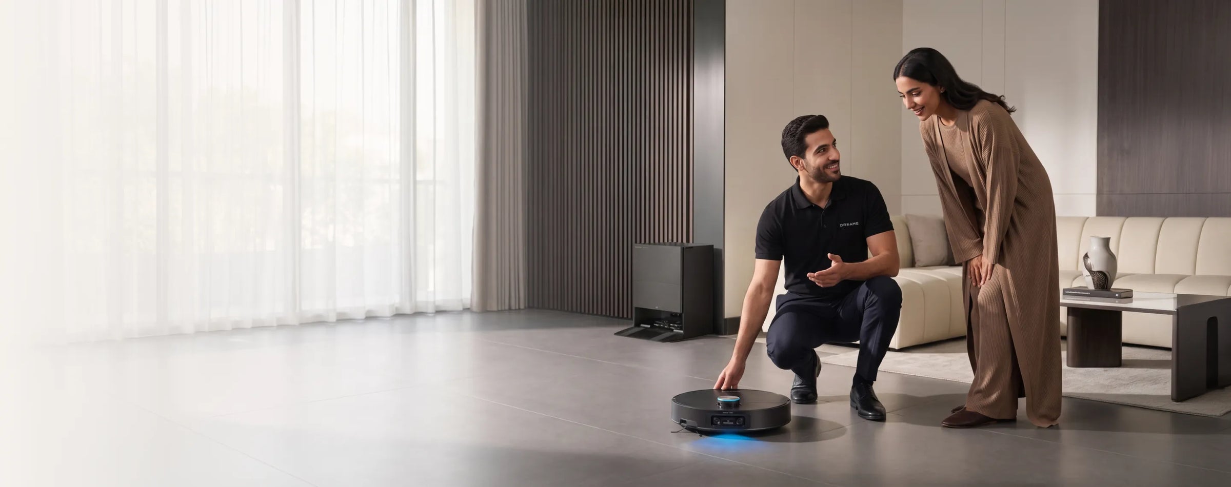 Dreame expert demonstrating a robot vacuum to a customer at home